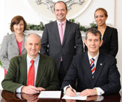 Health Minister Edwin Poots signing MOU with Dr Ted Trimble, Mary Jackson, Dr Michael McBride and Isabel Otero