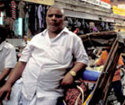 Overweight Indian man in busy street