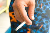 Close up of hand holding a smoking cigarette