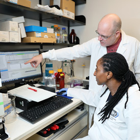 Dr. Nana Amissah from Ghana trains with NIH senior investigator Dr. Michael Otto as part of the African Postdoctoral Training Initiative (APTI). 