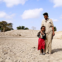 Courtesy of USAID in Africa Link, woman and her child stand at the bottom of a basin that used to be the community watering hole near the small town of Aje, Ethiopia