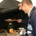 Man demonstrates cookstove during workshop