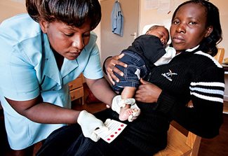 A nurse takes dried blood spot samples from an infant to test for HIV in a maternal and child health ward in a Malawi clinic.