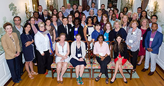 Large group of workshop attendees pose for a photo.