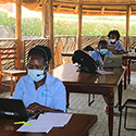 Three women on computers at Rakai Health Sciences Program in Uganda