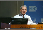 Screen capture of video of Dr Tony Fauci speaking at a podium