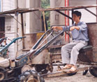 Chinese man sits on parked tractor