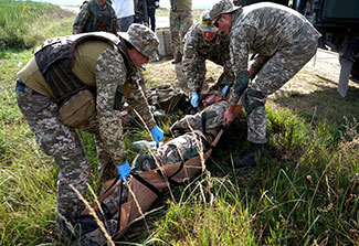 Ukrainian soldiers provide medical response to a simulated casualty situation during an Operational Capabilities Concept evaluation at the International Peacekeeping and Security Centre in Yavoriv, Ukraine, Sept. 11, 2018. The evaluation was being conducted by a multinational OCC evaluation team during the Rapid Trident exercise to assess Ukraine’s military interoperability capacity.