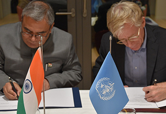 This photo shows Shri Indra Mani Pandey, Permanent Representative of India to the United Nations in Geneva, representing the Ministry of AYUSH, and the Republic of India (left) and Dr. Bruce Aylward, Assistant Director-General of the Universal Health Coverage and Life Course Division of WHO  (right)  signing an agreement to advance traditional, complementary, and integrative medicine between the two organizations. 