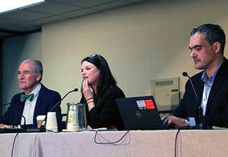 In this photo, Acting Fogarty Director Peter Kilmarx (left), Acting Deputy Director Rachel Sturke (middle), and Communications Director Andrey Kuzmichev (right) site at a table and listen to questions from the audience during the Fogarty Listening Session at CUGH 2024.