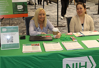 Kristen Weymouth (left) and Janelle Cruz (right) sitting at the Fogarty Table at CUGH