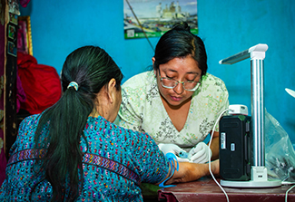 Community health worker provides care for hypertensive patient in Guatemala courtesy of Sean Duffy