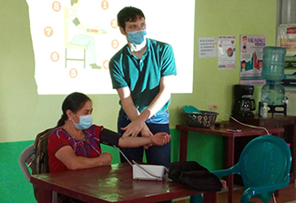 Dr. Sean Duffy teaches blood pressure measurement to community health workers in Guatemala courtesy of Sean Duffy