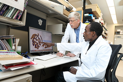 Director Dr. Francis Collins in the lab. Dr. Aimola is a African Postdoctoral Training Initiative