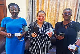 Betty Nartey (Left), Emma Lawrence (Middle), and Amanda Adu-Amankwah (Right), holding devices and smiling.