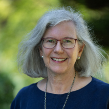 Headshot of Michele Ramsey, wearning a blue top and necklace, smiling