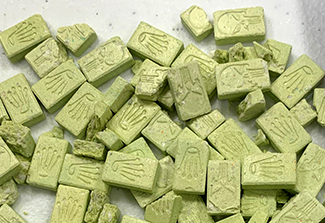 Photo of Ecstasy pills scattered on a table