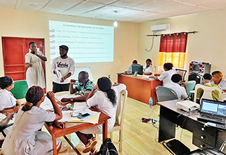 Dr. Robert Samuels provides data training to healthcare workers in the pediatric ward at Kenema Government Hospital