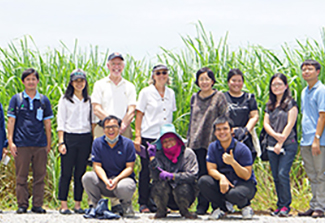 The photograph on this page shows the GEO Health Hub team standing in front of an agricultural field in Thailand.