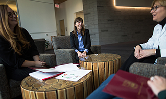 Dr. Emily Anderson (middle),  talks with fellow faculty and students in the Center for Translational Research and Education on Loyola's Health Sciences Campus