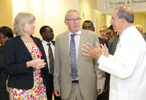 Zambian Second Lady Charlotte Scott and Vice President Guy Scott in hallway of NIH clinical center listen to Dr Gallin