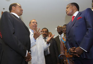 NIH clinical center Dir Gallin wearing white coat gestures with hands while giving tour to African presidents, delegates