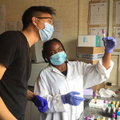 Andrew Kim working with samples in a lab with a colleague