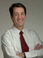 Headshot of Dr Christopher P Austin