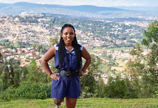 Claudine Humure stands on a hill overlooking city. Her high-tech prosthetic leg, top of which is shown, helped her achieve greater mobility