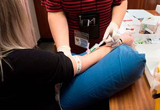 A staff member draws a blood sample from a volunteer at the start of a clinical trial being set up by TASK, a clinical research organisation based in Cape Town, South Africa.