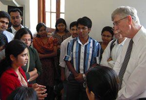 NIH Director Dr Francis Collins listens attentively to a young woman among a large group of Indian students