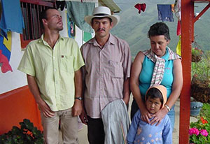 A family in Colombia on the porch, mountains in background