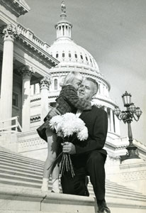 On the steps of the U.S. Capitol Congressman Fogarty holds his young daughter and a boquet of flowers