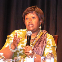 Close up of Dr. Agnes Binagwaho speaking into microphone, gesturing with hands