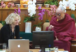 NIDA Director Dr Nora D Volkow seated next to the Dalai Lama, both look at computer screens