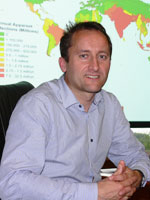 Dr Andrew Farlow seated in front of a projected map