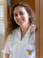 Dr Patricia Garcia in a while lab coat in the doorway of her office at UPCH