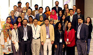 Large group of researchers pose for camera during workshop