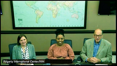 During her talk at the Fogarty International Center at NIH, Claudine Humure (center) smiles as the event wraps up with Theresa Cruz on her right and Roger Glass on her left.