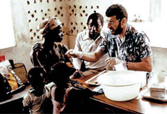 This photo shows Joel Breman taking blood from a woman in Brazzaville, Congo, in 1978. Two children and a man observe.