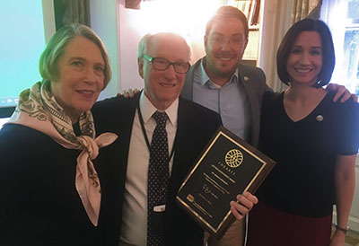 Dr. Ken Bridbord receives award surrounded by his family