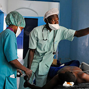 Nadife, a nurse assistant, and Chadian army Chief Adjutant Mahamat Saleh, chief anesthetist, both of the Military Teaching Hospital in N’Djamena, Chad, administer an IV solution to a patient prior to surgery April 15.