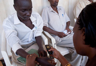 A medical worker checks the bloodpressure of a patient in a clinic