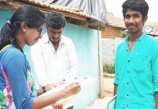 A researcher (left) interviews two men in India to gather information about the underlying concepts of masculinity and how they are formed.