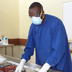 Dr. Edwin Walong wears protective equipment while working in a lab.