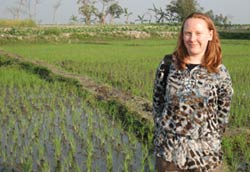 Dr. Juliet Pullium stands in front of a field
