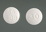 Close up of two white morphine pills.