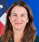 Headshot of Bathsheba Nell Crocker with part of an American flag in the background