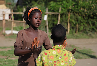 Sister and brother, who nearly died of a combination of malaria and meningitis, play. Courtesy of USAID in Africa