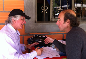 Dr Francisco Lopera and Dr Kenneth Kosik collaborate while seated around an outdoor table